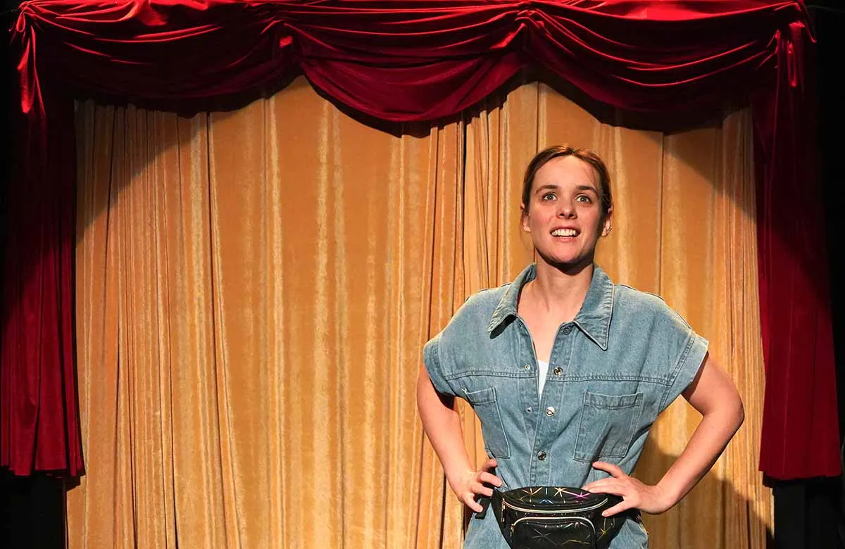 Charlie Russell performing her solo show at Pleasance Courtyard