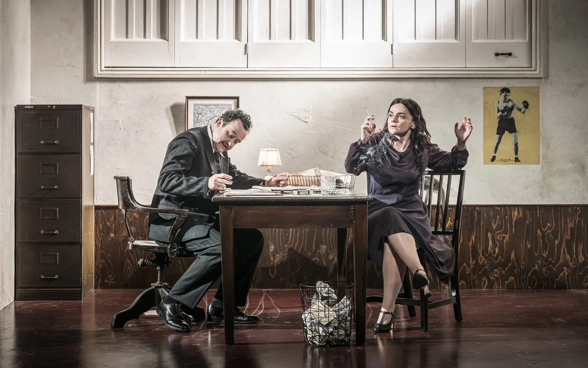 Two characters face off across an office desk, Golden Boy at the Almeida Theatre