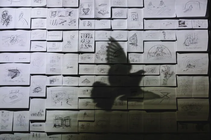 The shadow of a bird in flight cast across a wall of Es Devlin's sketchbook pages, 3rd Poem at FUTURA SEOUL